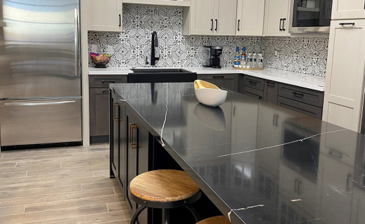 A new full-sized state-of-the-art working kitchen is going in right now complete with stunning waterfall countertops, plenty of cabinet storage space, voice activated faucet, upgraded hardware and appliances.