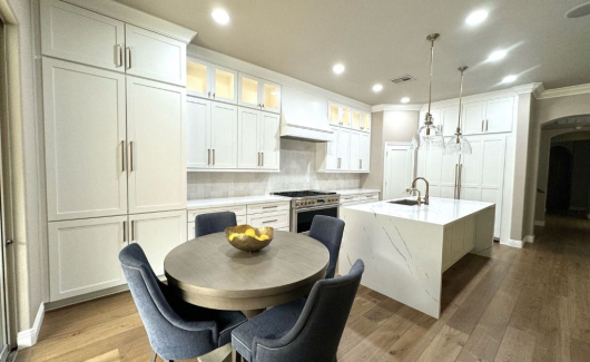 This luxurious kitchen remodel features Wellborn's Glacier White Cabinetry. The floor-to-ceiling cabinets help add a touch of elegance while maximizing storage space. [TWD Project Location: Peoria, AZ]