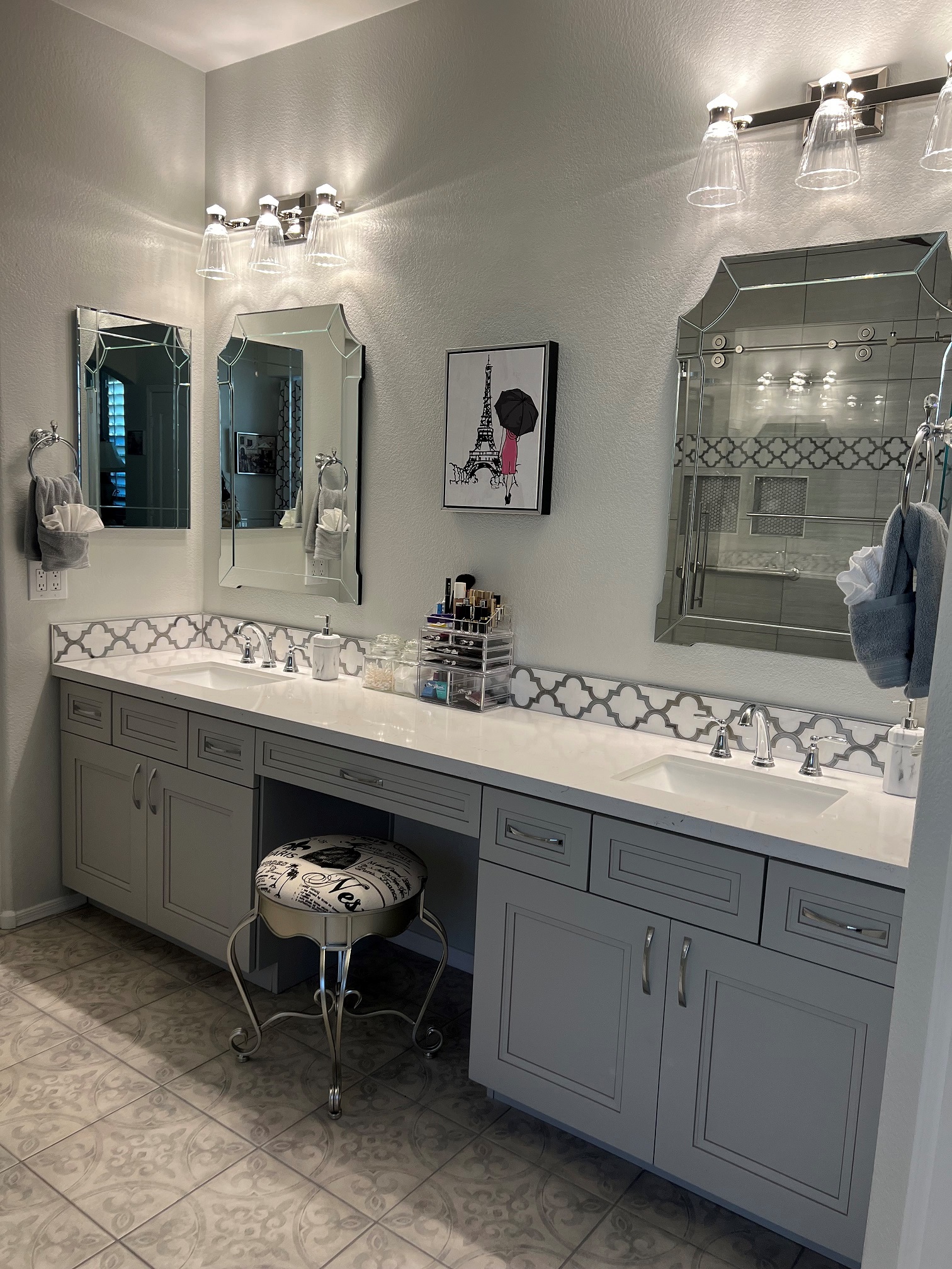 Master Bathroom featuring gorgeous Moonstone Mosaic tile backsplash topping the Calcatta quartz slab countertop. New chrome plumbing trim with matching customer supplied mirrors and lighting add a touch of glam to this overall design. [TWD Project Location: Surprise, AZ]