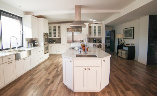 This full home renovation went from a complete gut to completely gorgeous. The kitchen features Wellborn Premier series cabinetry in a Glacier White finish with quartz countertop, gray ceramic tile backsplash, (2) kitchen sinks, stainless steel appliances and hood. [TWD Project Location: Litchfield Park, AZ]