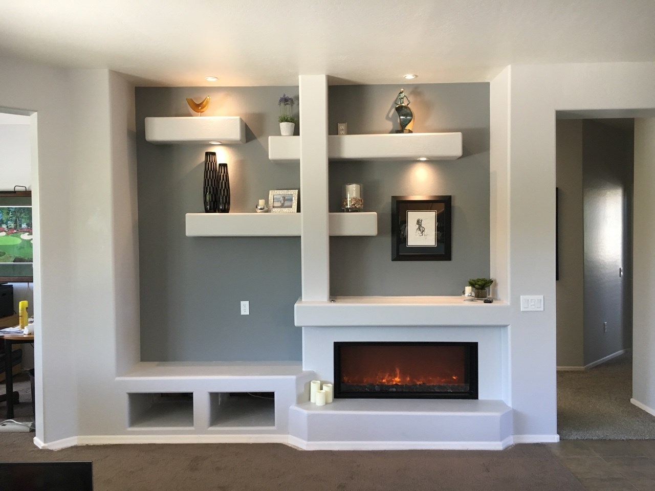 This 10'-0" x 9'-0" media center area features multi-tiered drywall shelving, a 40" electric fireplace, relocation of electrical, a dedicated circuit for the fireplace and LED lighting. [TWD Project Location: Surprise, AZ]