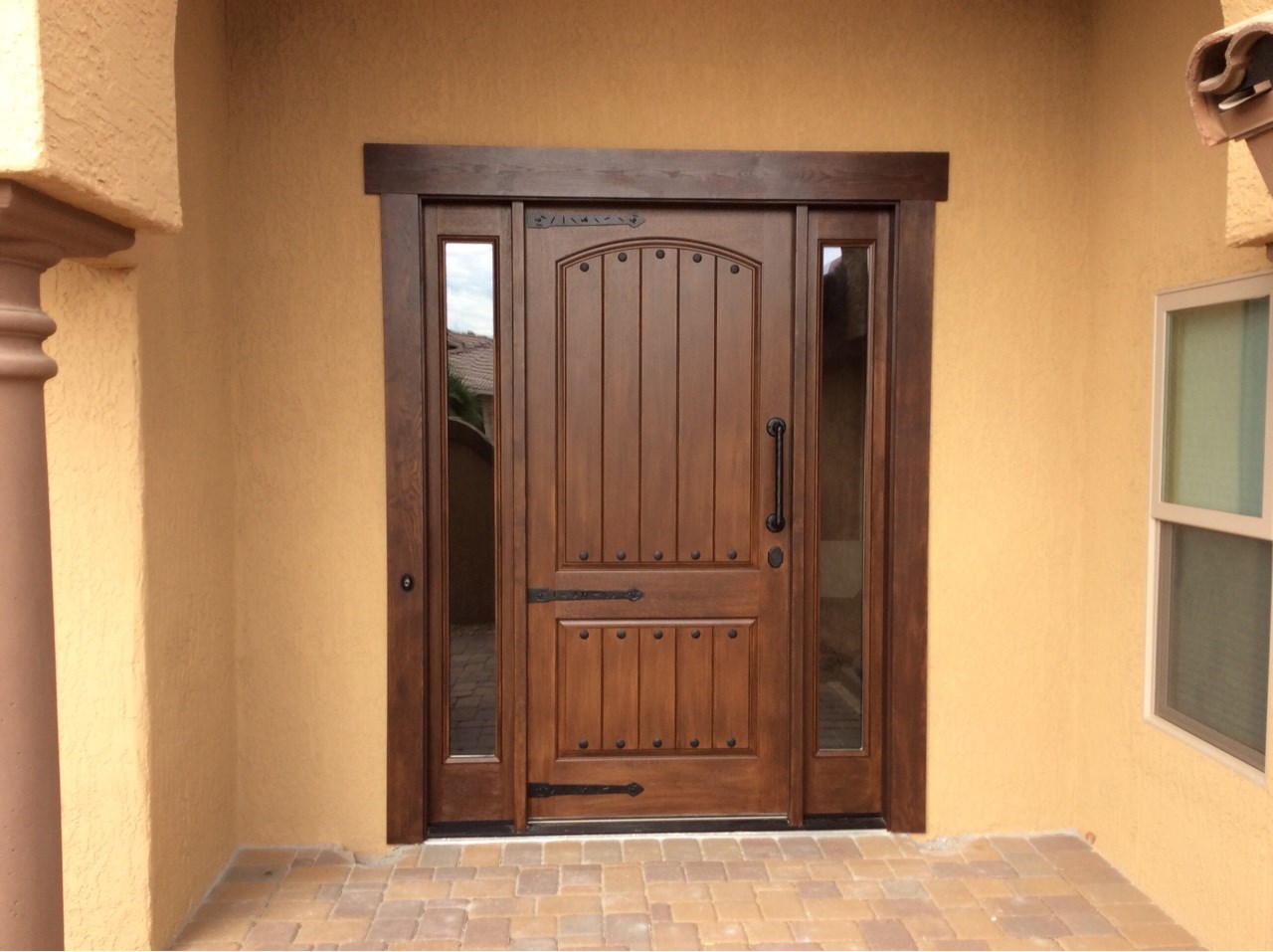 Thermatru stained entry door with side lites and bronze hardware for a grand entrance. [TWD Project Location: Sun City West, AZ]