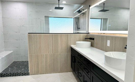 This Master Bathroom renovation turned an ordinary bath into a fabulous spa-like retreat that the homeowners are absolutely loving. The natural light from the window and LED backlit mirrors really brighten up the space, while the mix of tile textures and patterns create a cohesive natural feel. [TWD Project Location: Surprise, AZ]