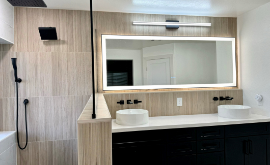 This Master Bathroom renovation turned an ordinary bath into a fabulous spa-like retreat that the homeowners are absolutely loving. The natural light from the window and LED backlit mirrors really brighten up the space, while the mix of tile textures and patterns create a cohesive natural feel. [TWD Project Location: Surprise, AZ]