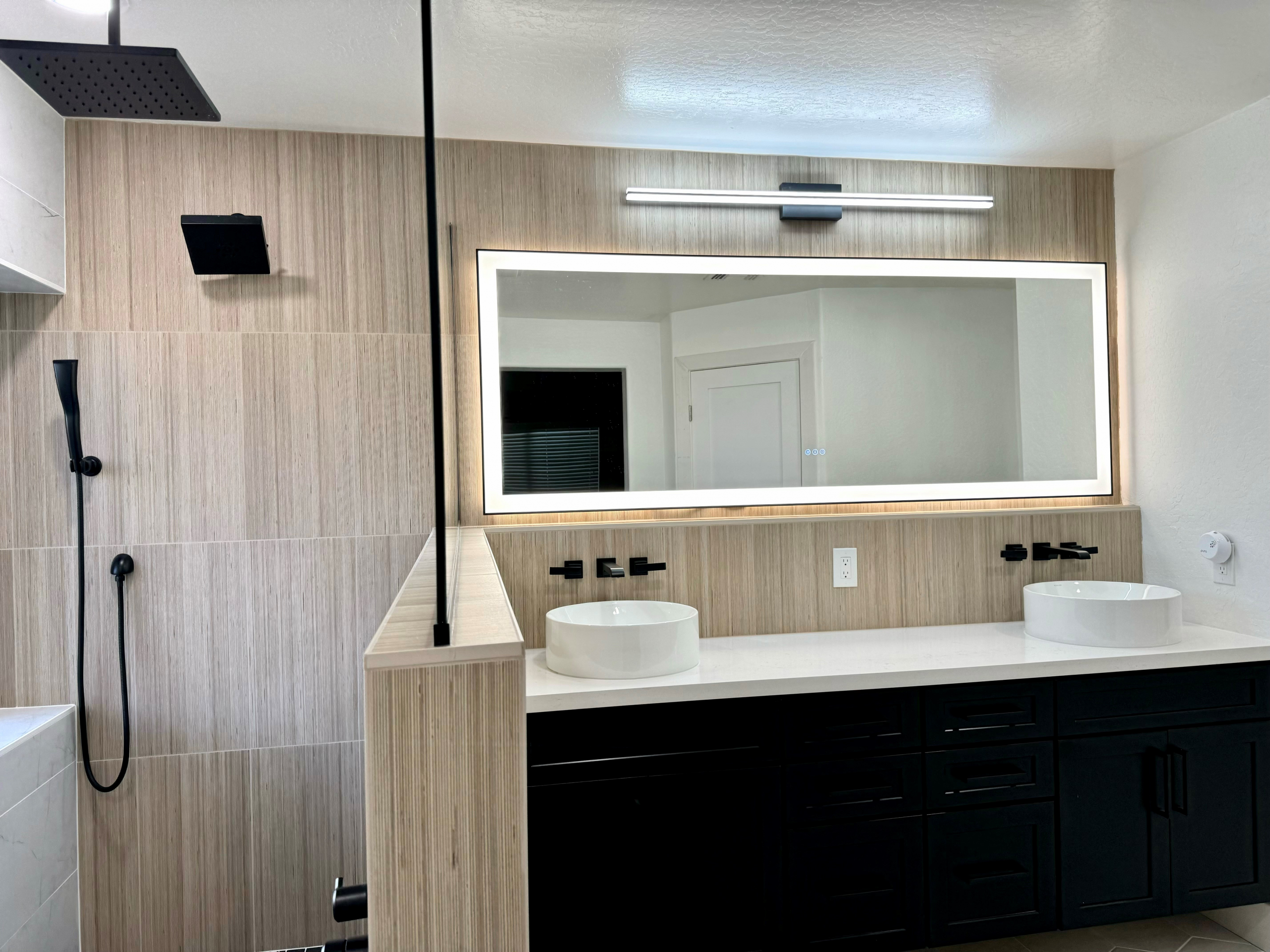 This Master Bathroom renovation turned an ordinary bath into a fabulous spa-like retreat that the homeowners are absolutely loving. The natural light from the window and LED backlit mirrors really brighten up the space, while the mix of tile textures and patterns create a cohesive natural feel. [TWD Project Location: Surprise, AZ]