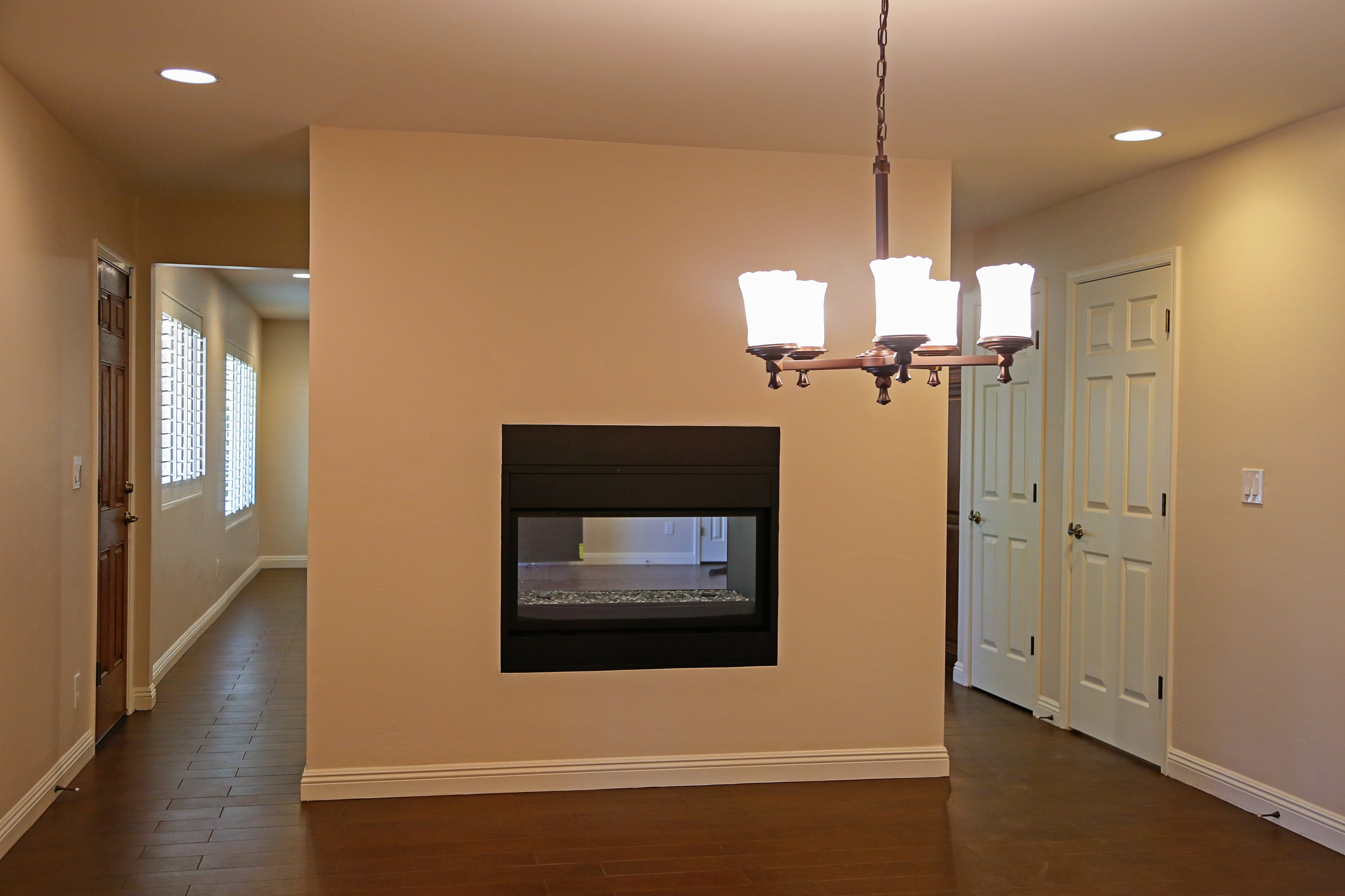 Open spacious floor plans are a sought after commodity, but in some circumstances a partial divider wall is a great addition to your home with a dual-sided fireplace. [TWD Project Location: Phoenix, AZ]