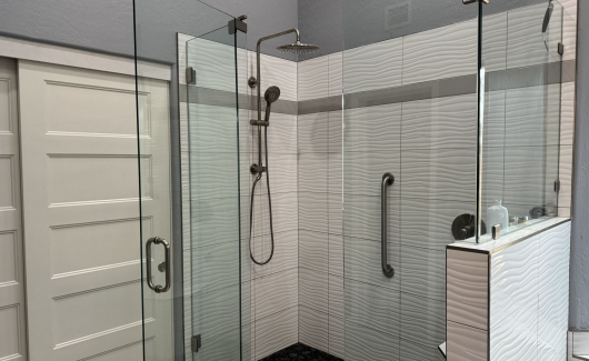 This over-sized walk-in shower with contemporary ripple glossy 3-D tile gives this Master Bathroom remodel a fresh new look. [TWD Project Location: Scottsdale, AZ]