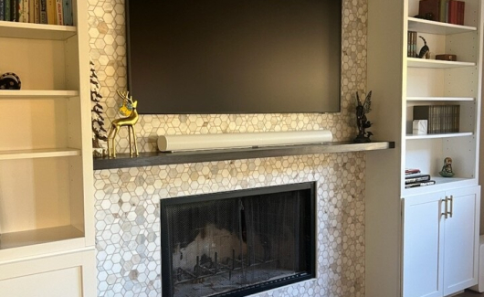 This full home remodel included a new fireplace wall that will be an ideal gathering spot for the family. Designed with Waypoint Living Spaces cabinetry in a Painted Linen finish and marble hex tile. [TWD Project Location: Phoenix, AZ]