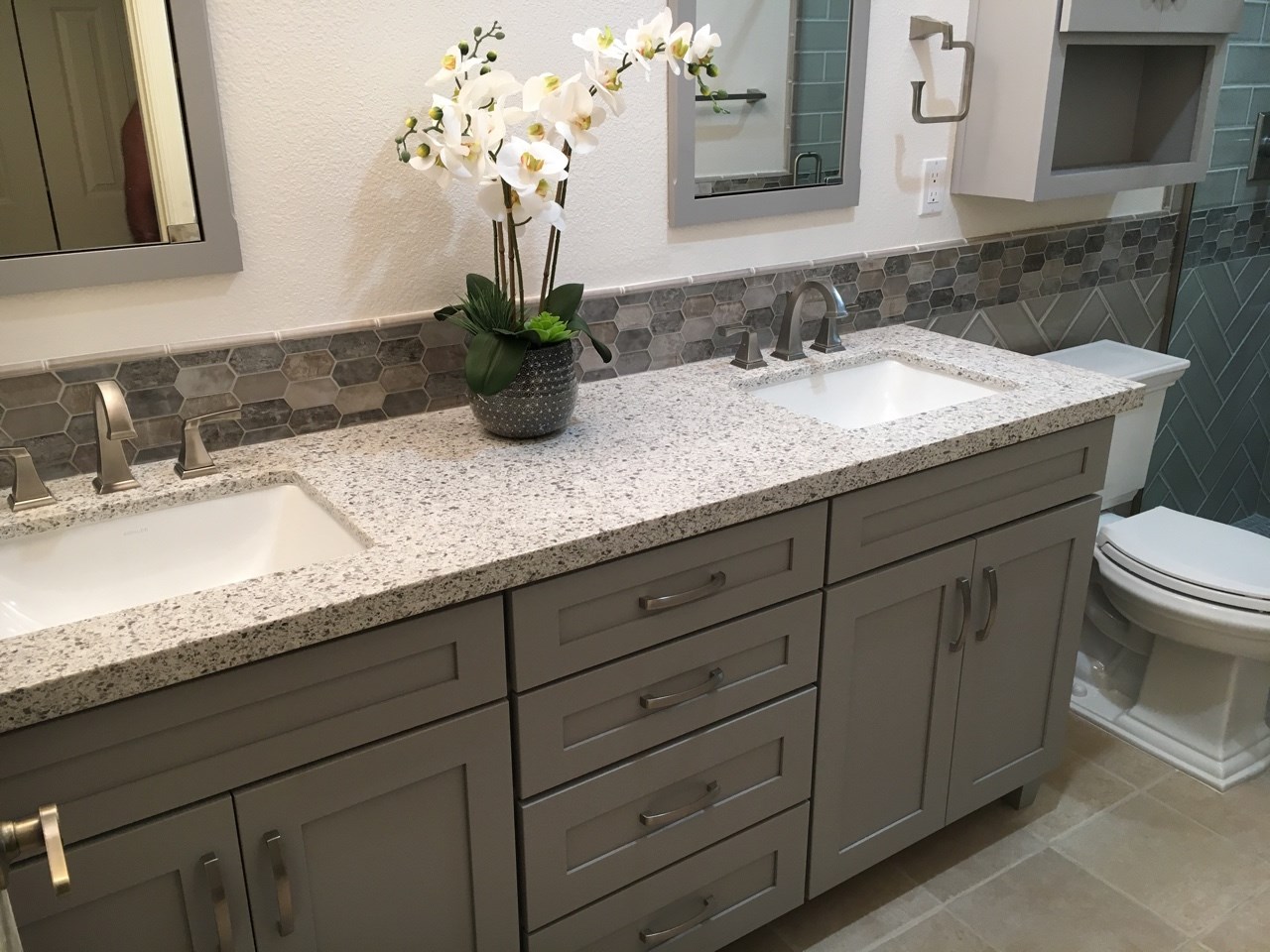 Prairie style shaker cabinetry with Dove Gray Paint paired perfectly with the quartz countertops and glass mosaic backsplash. [TWD Project Location: Peoria, AZ]