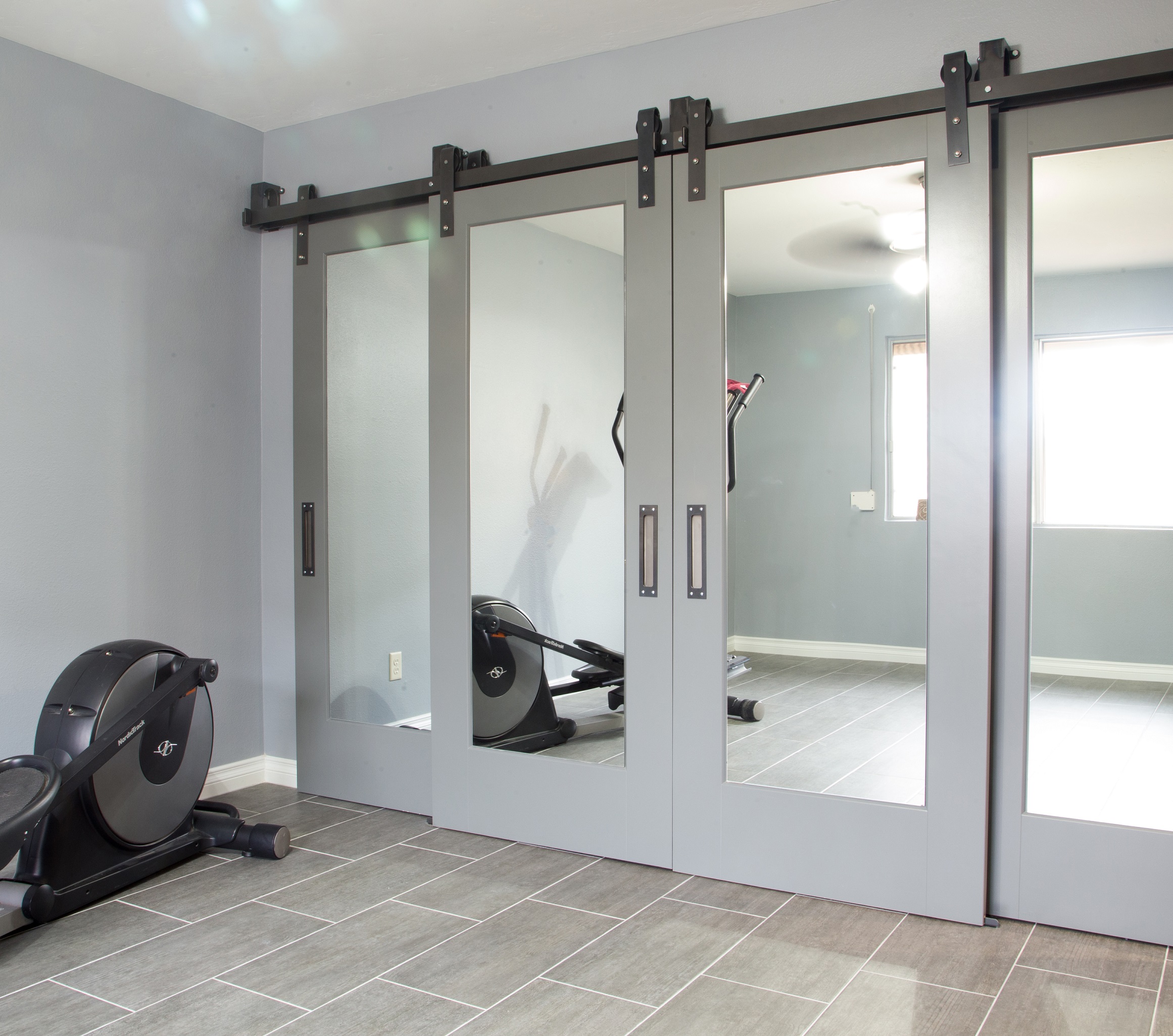 Gorgeous Master Suite Remodel featuring shaker recessed panel interior sliding barn doors with raw steel barn door track and 12" x 24" porcelain tile. [TWD Project Location: Glendale, AZ]