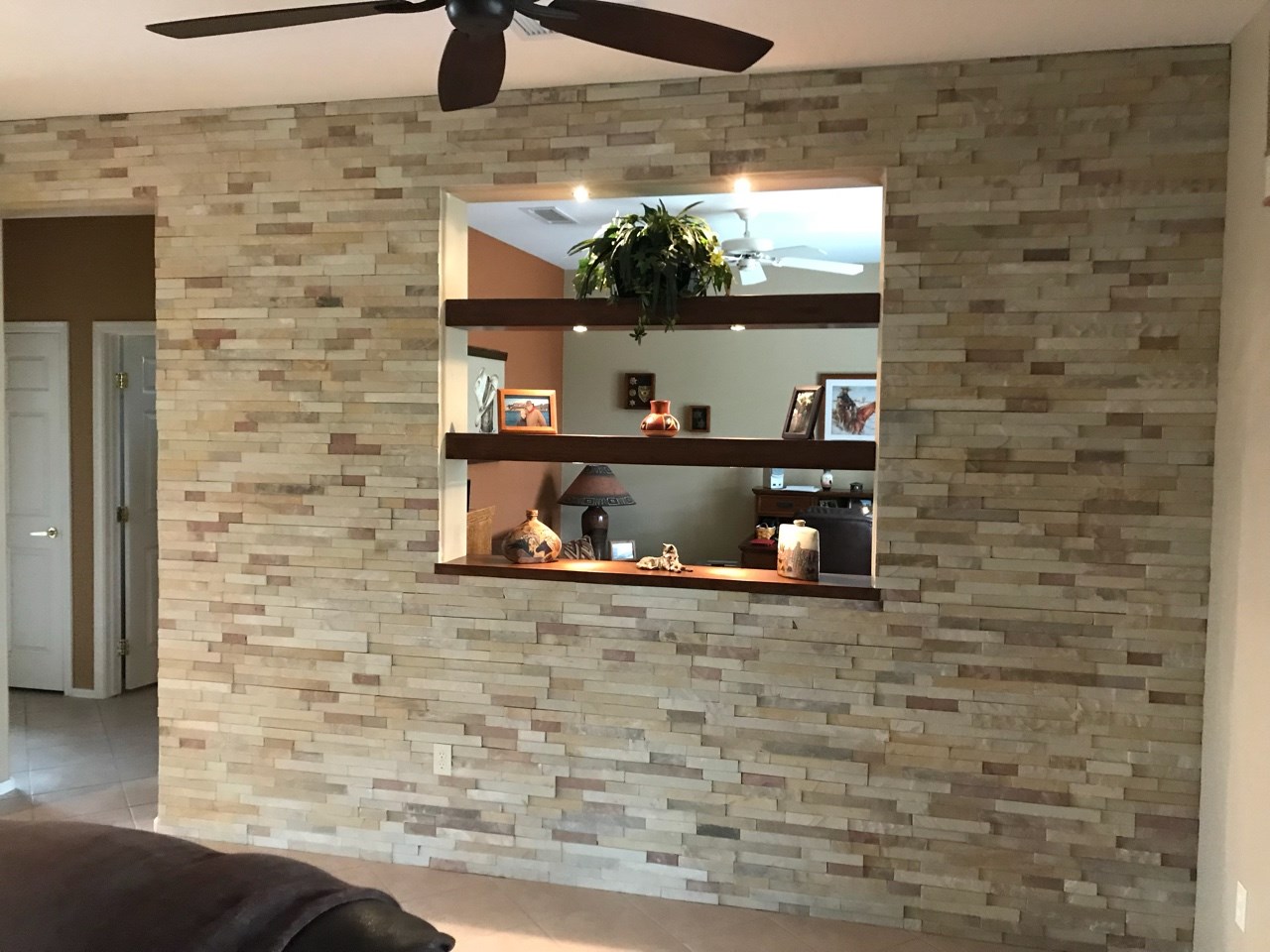 Supply and install architectural ledger stone at the Family Room/Den Pass-thru wall with custom wood shelving. [TWD Project Location: Surprise, AZ]