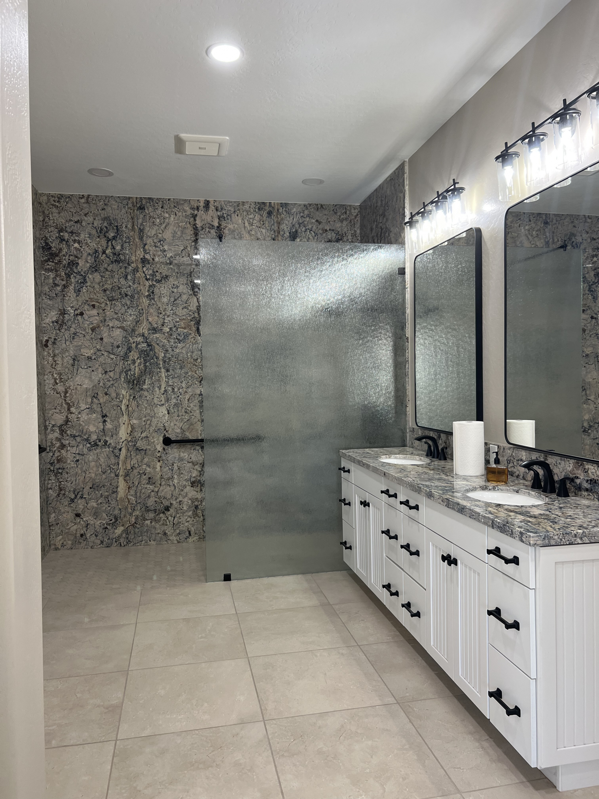 This full home renovation included a Master Bathroom with granite panels used in the open walk-in shower from floor to ceiling. [TWD Project Location: Glendale, AZ]