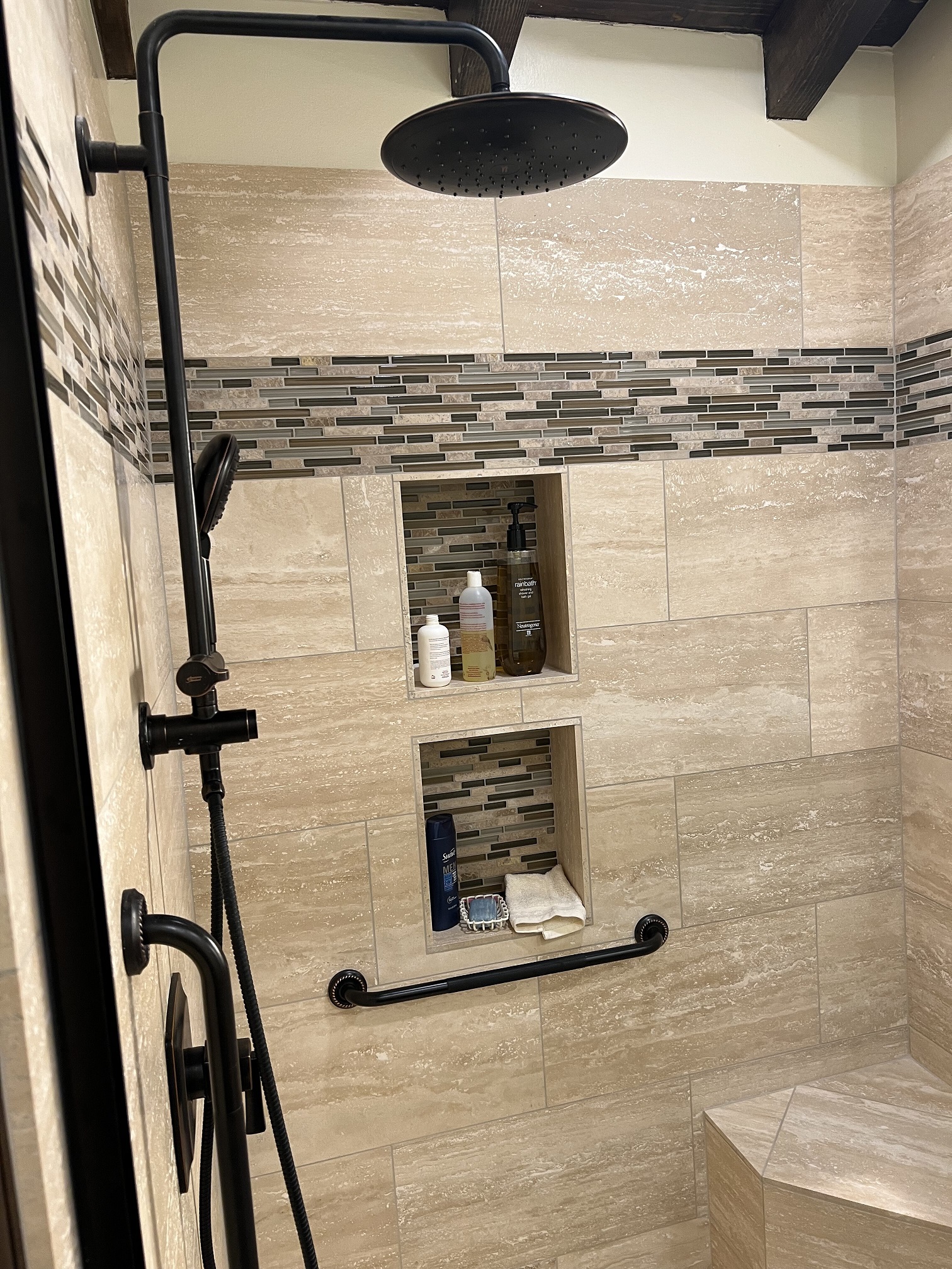 Rainfall shower, handheld shower, seating, spacious niches, and grab bars are all features to consider when planning your shower remodel. [TWD Project Location: Phoenix, AZ]