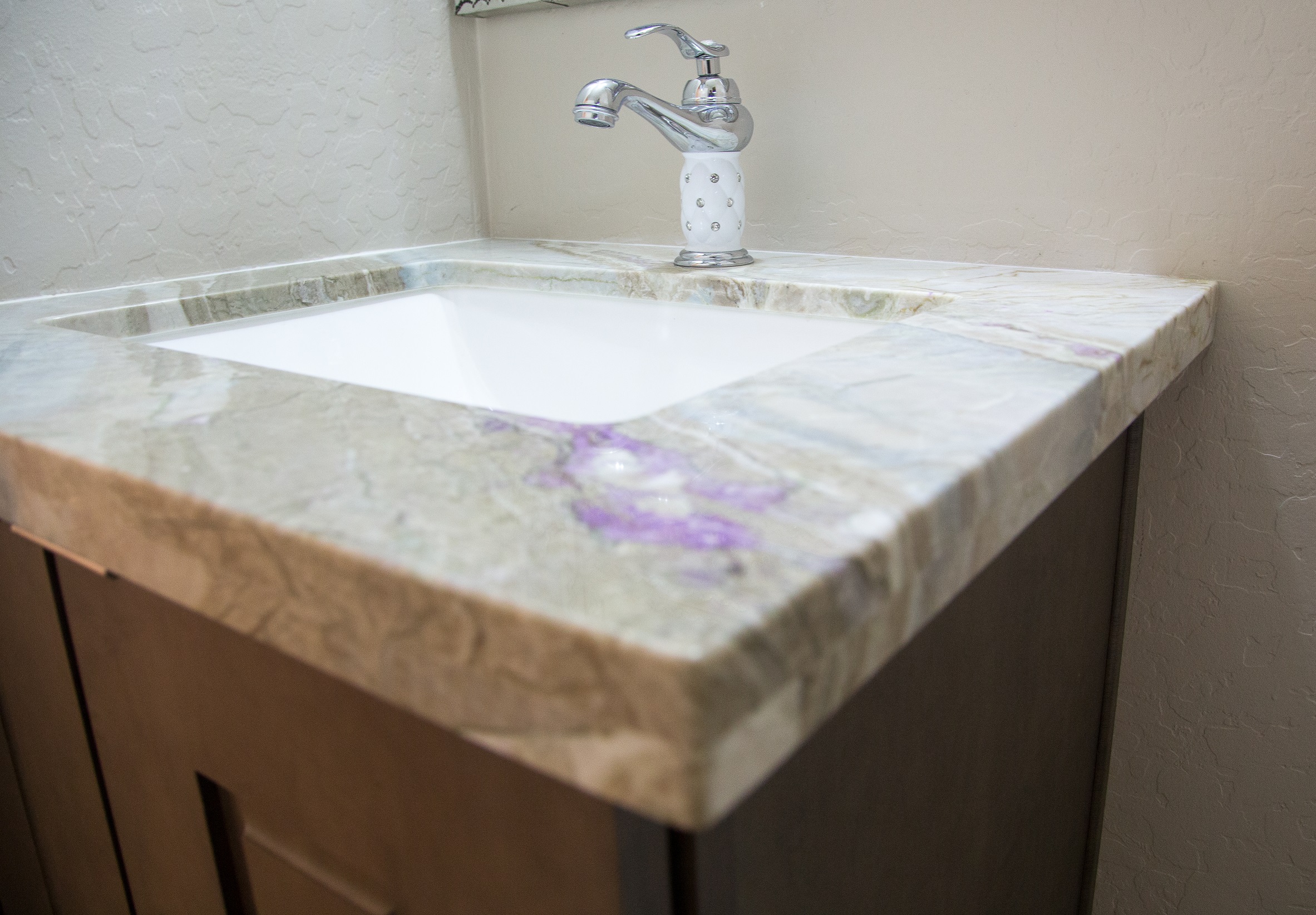 Stunning Corteccia quartz countertops with purple accents featured int he Kitchen and Bathroom of this Valley home. [TWD Project Location: Surprise, AZ]