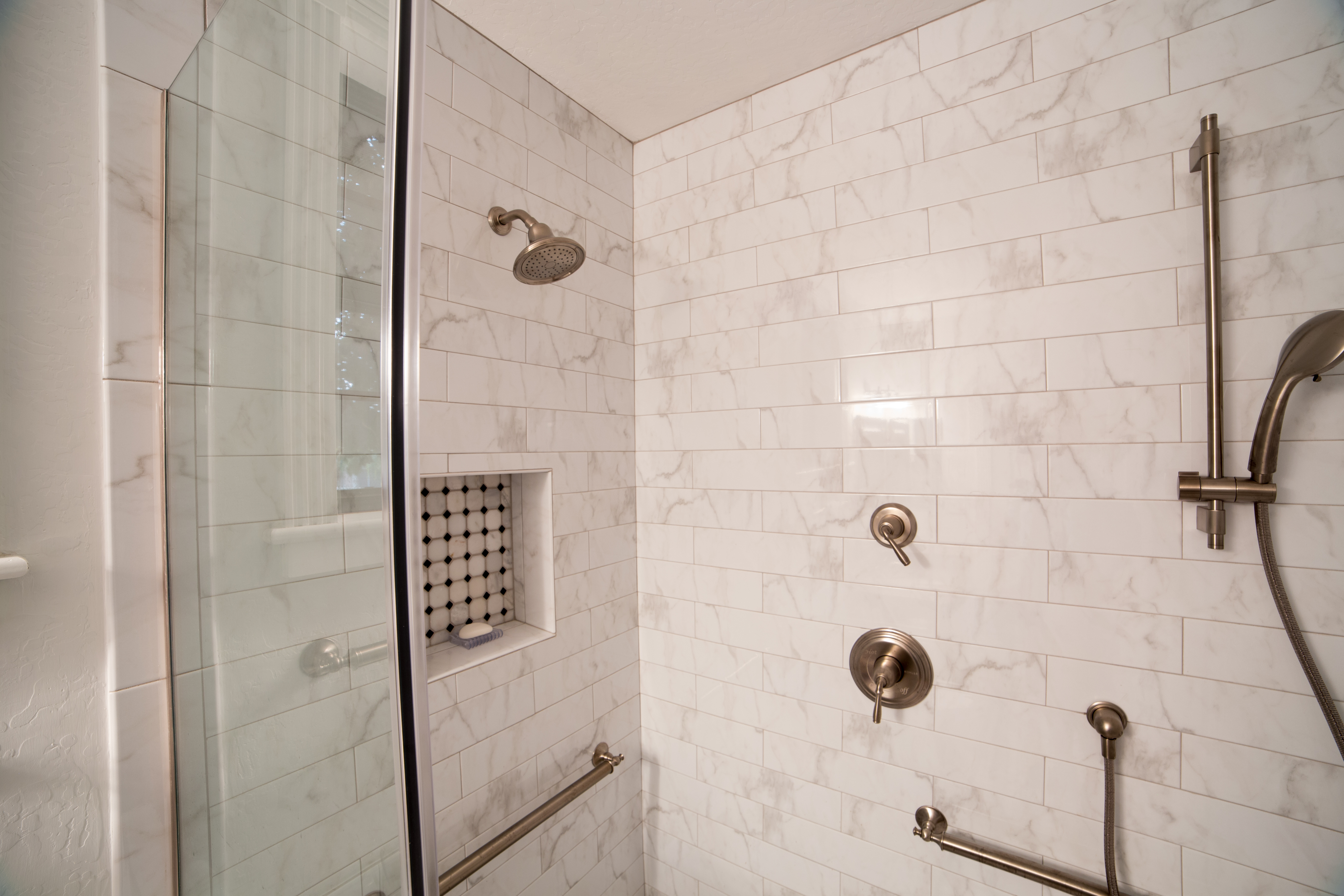 Universal Design can be incorporated into the stunning details without overtaking the design of the space. This shower features plenty of decorative "grab bars" for stability. [TWD Project Location: Glendale, AZ]