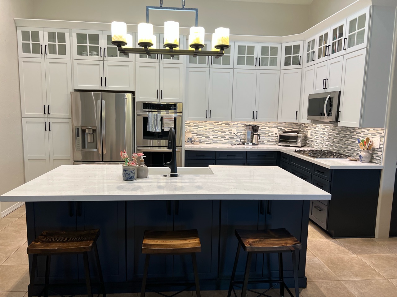 TWD was honored to remodel multiple rooms within this Valley home. The kitchen came out absolutely striking. This space features plenty of storage capacity with the two-toned cabinetry in Linen and in Navy from Waypoint, North Cascades Quartz countertops, backsplash tile from Bedrosians and all of the fine details and options included. [TWD Project Location: Goodyear, AZ]