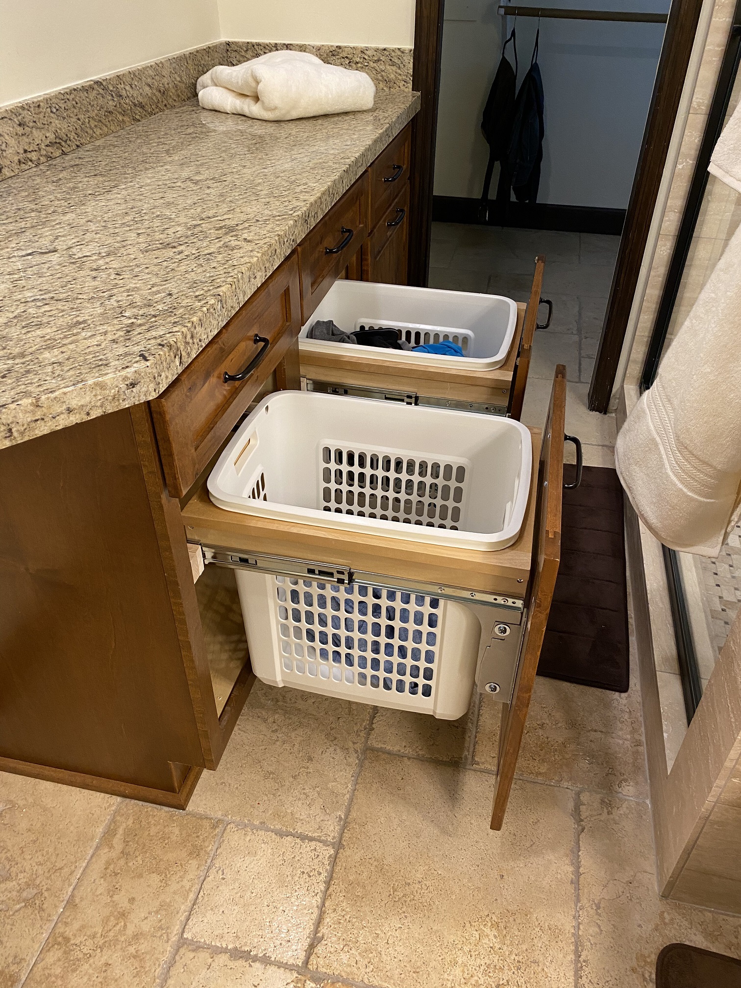 Incorporating hidden hampers within your bathroom design is a great ideal to help keep laundry out of sight. [TWD Project Location: Phoenix, AZ]