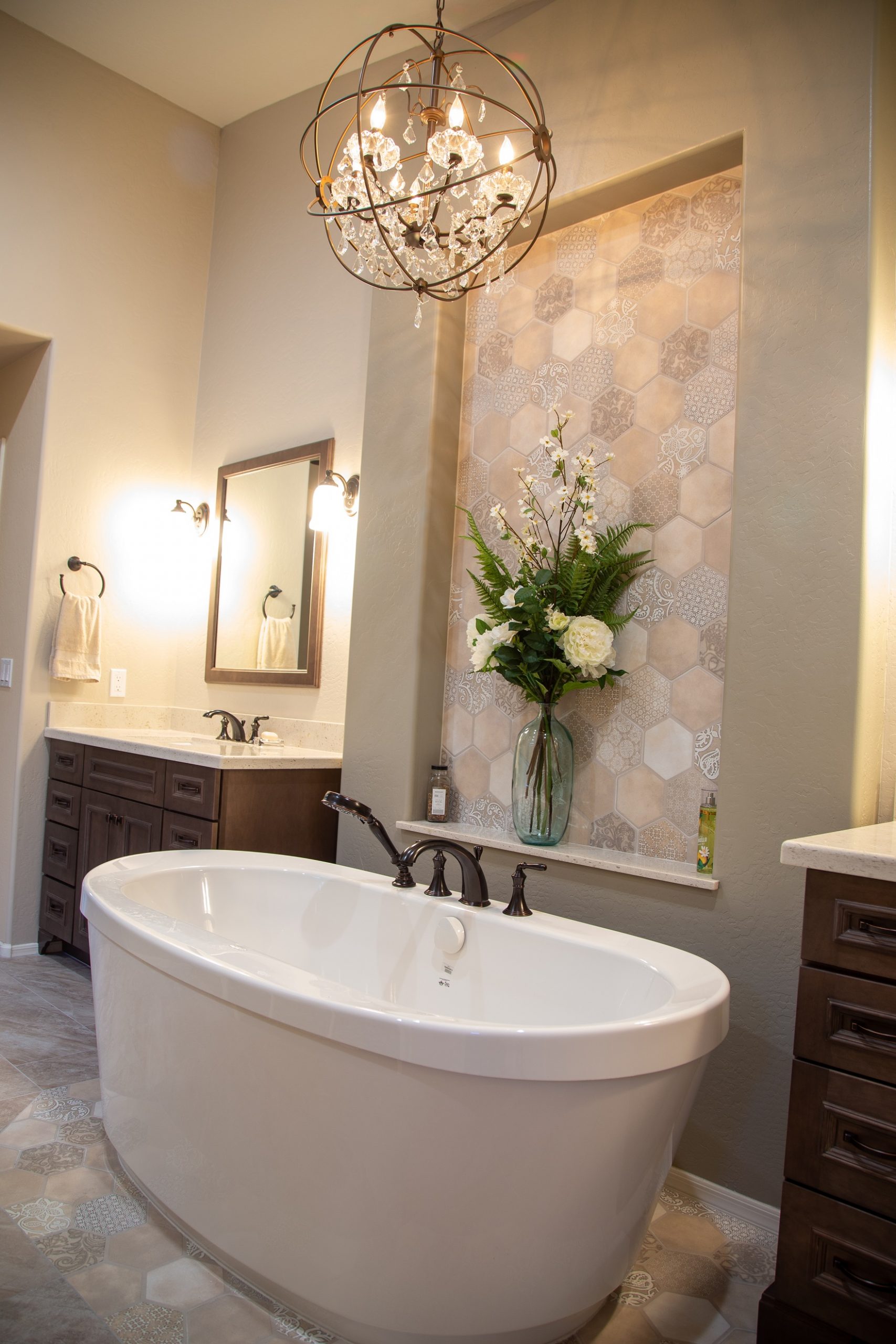 From an ordinary bathroom to a stunning master bathroom to love. This remodel features separated Wellborn vanities, a spacious walk-in shower with drying area, and a soaking tub carefully placed upon gorgeous hexagon mosaic tile to complete this magazine worthy look.  [TWD Project Location: Peoria, AZ]