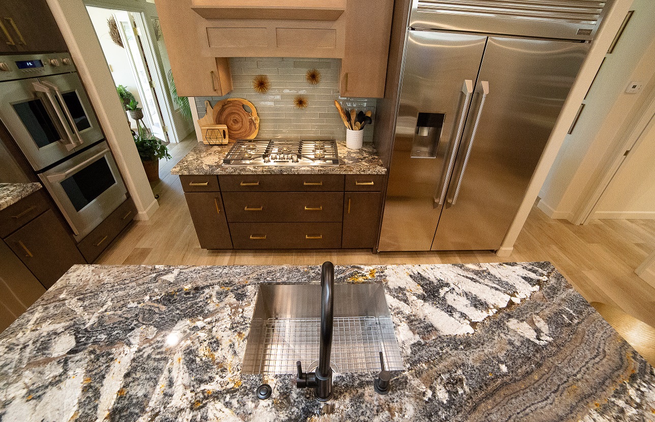 This stunning kitchen remodel features dual islands, dual Wellborn Premier cabinetry colors, gorgeous granite, grey glass tile backsplash and special attention to all of the little details that complete this look. [TWD Project Location: Sun City West, AZ]