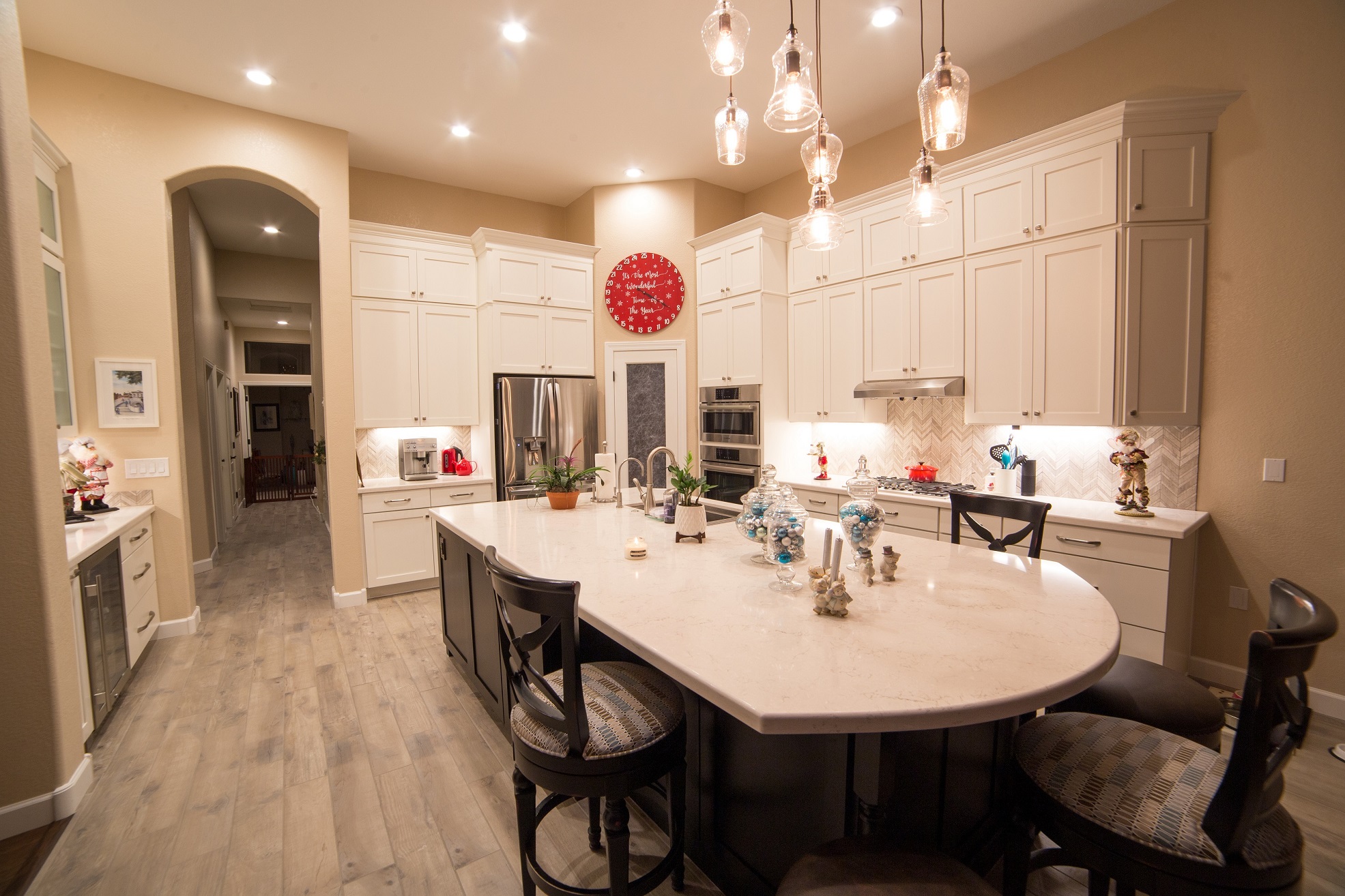 Gorgeous full home renovation. The kitchen features two toned cabinetry, quartz countertops, chevron stone mosaic backsplash, dedicated coffee station, 27" deep wine refrigerator cabinet panels with glass inserts, 36" porcelain wood-like plank flooring, and all of the detailed finishes to bring the look together. [TWD Project Location: Scottsdale, AZ]