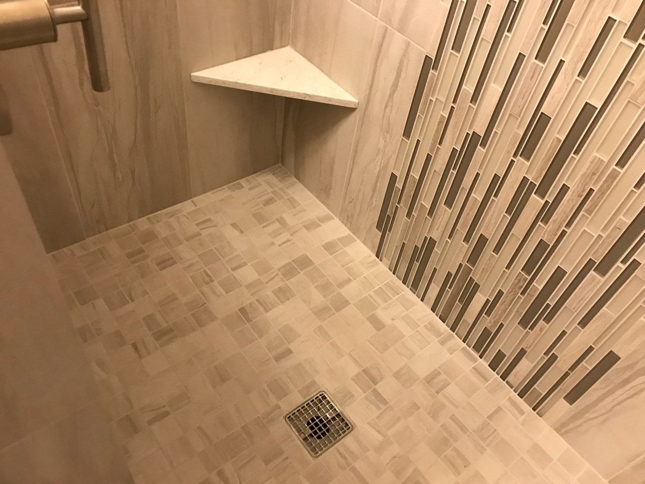 The previous tub/shower combo doesn't compare to the new walk in shower with 12"x24" porcelain tile, 2"x2" porcelain mosaic and stacked glass mosaic tile. [TWD Project Location: Goodyear, AZ]