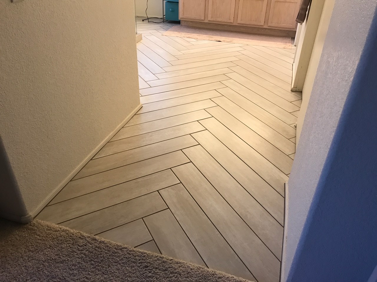 Plank tile in a herringbone pattern. [TWD Project Location: Glendale, AZ]