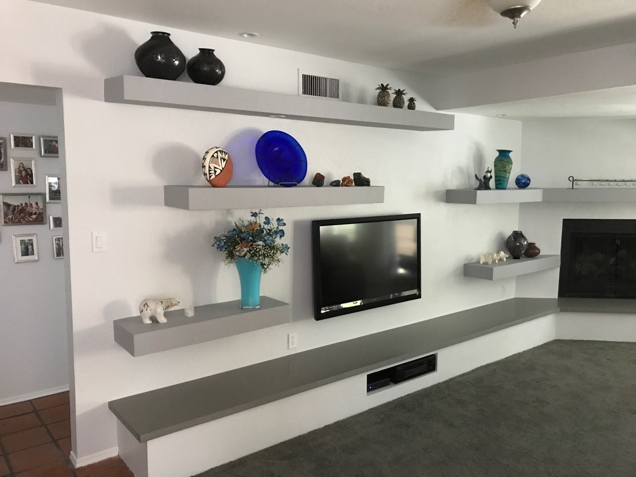 This open wall space now holds drywall floating shelves, a hearth extension with A/V niche, and a quartz countertop. [TWD Project Location: Phoenix, AZ]