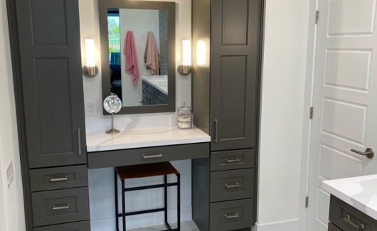 This master suite bathroom design features his and her sinks and a separate dedicated makeup area with an abundance cabinet storage. The newly designed bathroom provides dual entrances to the glamorous new walk-in closet. [TWD Project Location: Litchfield Park, AZ]