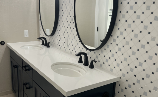 Navy cabinets by Waypoint Living Spaces make a statement in this hall bathroom renovation. [TWD Project Location: Glendale, AZ]