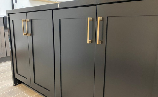 The TWD Phoenix Design Showroom features the most current color trends, like this equisite kitchen island showcasing Wellborn cabinetry, cabinet hardware and waterfall top. 