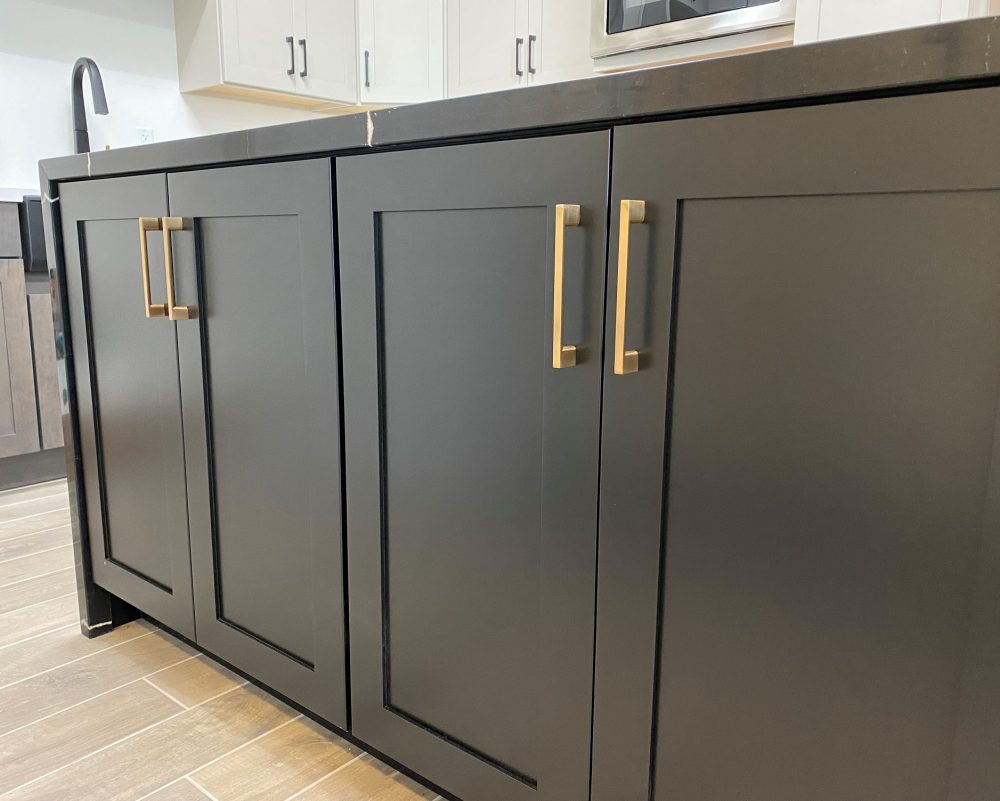 The TWD Phoenix Design Showroom features the most current color trends, like this equisite kitchen island showcasing Wellborn cabinetry, cabinet hardware and waterfall top. 