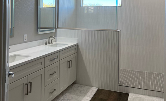 White evokes feelings of being clean and pristine making it an ideal color choice for your bathroom design. Towels, decor and other linens can easily be added for a pop of color in your space. [TWD Project Location: Peoria, AZ]