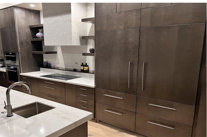 A modern kitchen featuring sleek dark brown cabinets with minimalist handles, white marble countertops, and open shelving, highlighting contemporary home design trends.