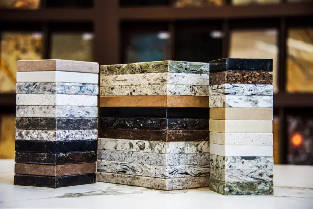 A display of natural stone countertop samples, showcasing a variety of colors and textures, including granite, marble, and quartz options, ideal for kitchen and bathroom renovations.